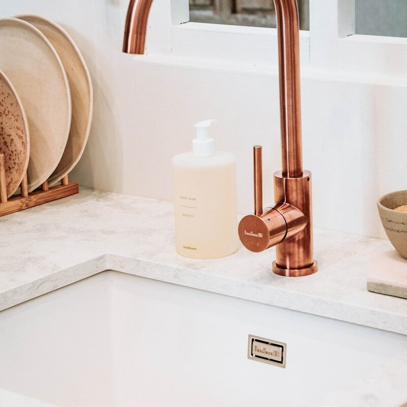 square white sink with brass faucet